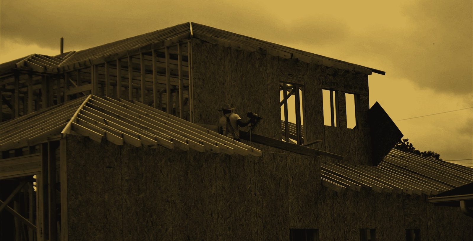 A contractor framing a roof on a residential job site